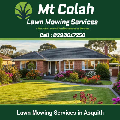 Freshly mowed lawn with neat stripes at brick home with garden beds in Asquith